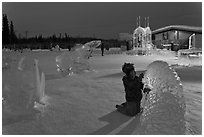 Child amongst ice sculptures at dusk. Fairbanks, Alaska, USA ( black and white)