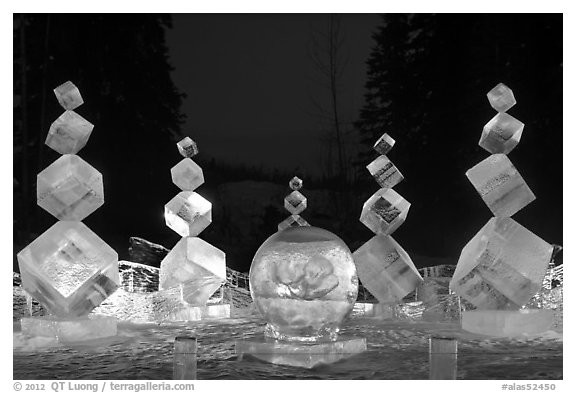 Balancing cubes made of ice at night, World Ice Art Championships. Fairbanks, Alaska, USA (black and white)