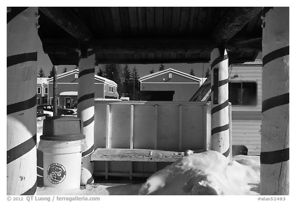 Bus stop with red candy-like stripped columns. North Pole, Alaska, USA (black and white)