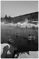 People soak in natural hot springs in winter. Chena Hot Springs, Alaska, USA (black and white)