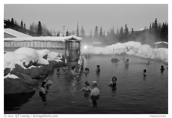 People soaking in outdoor hot springs pool in winter. Chena Hot Springs, Alaska, USA (black and white)
