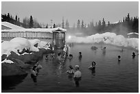 People soaking in outdoor hot springs pool in winter. Chena Hot Springs, Alaska, USA (black and white)