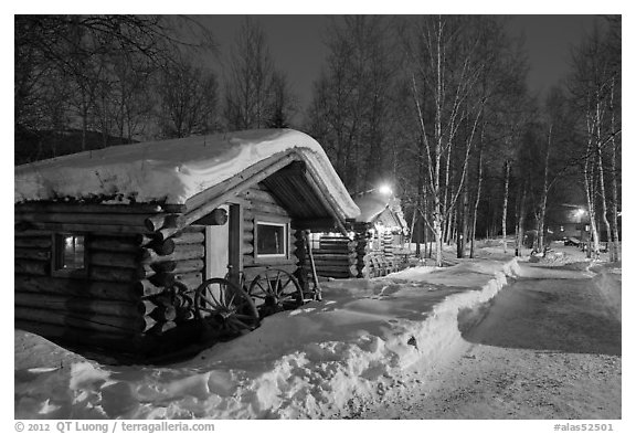 Path in snow and cabins at night. Chena Hot Springs, Alaska, USA