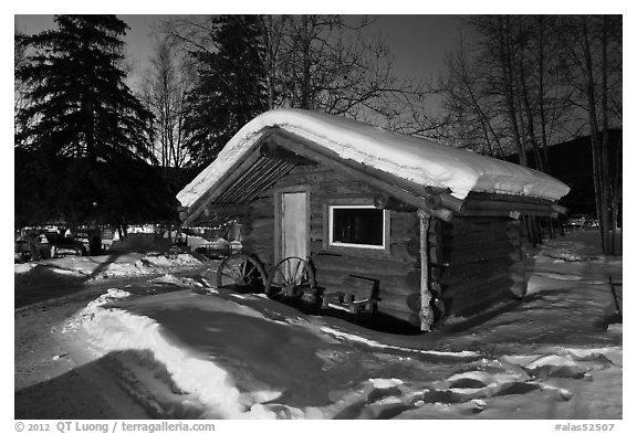 Snowy log cabin at night. Chena Hot Springs, Alaska, USA