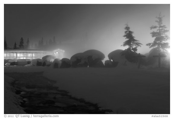 Stream, steam, and bathhouse at night. Chena Hot Springs, Alaska, USA (black and white)
