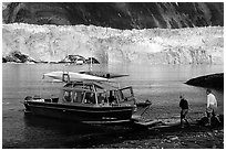 Water taxi boats lands on Black Sand Beach. Prince William Sound, Alaska, USA ( black and white)