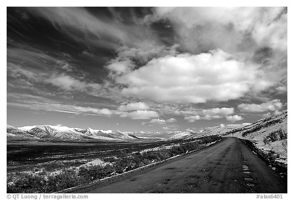Denali Highway under large white clouds. Alaska, USA (black and white)