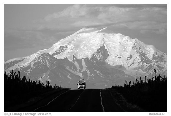 Car on Glenn Highway with Wrangell range peak behind. Alaska, USA (black and white)