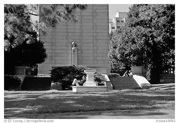 Reading at the base of the Campanile on the UC Campus. Berkeley, California, USA (black and white)