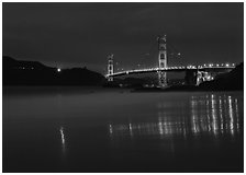 Golden Gate Bridge reflected in wet sand, blue hour. San Francisco, California, USA ( black and white)