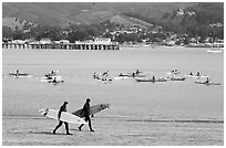 Surfers and sea kayakers, Pillar point harbor. Half Moon Bay, California, USA ( black and white)