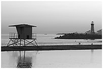 Beach cabin and lighthouse, Twin Lakes State Beach, sunset. Santa Cruz, California, USA (black and white)