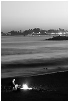 Bonfire on the beach at sunset. Santa Cruz, California, USA ( black and white)