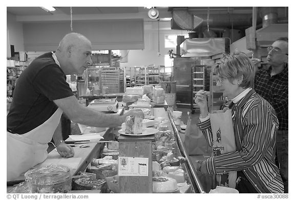 Choosing cheese at the Cheese Board. Berkeley, California, USA (black and white)