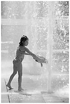 Girl refreshing herself, Cesar de Chavez Park. San Jose, California, USA (black and white)