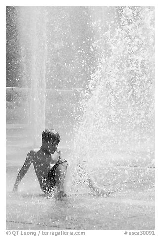 Boy playing in water,  Cesar de Chavez Park. San Jose, California, USA