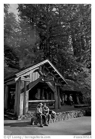 Couple sitting in front of park headquarters, afternoon. Big Basin Redwoods State Park,  California, USA (black and white)