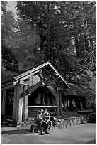 Couple sitting in front of park headquarters, afternoon. Big Basin Redwoods State Park,  California, USA ( black and white)