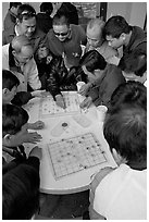Vietnamese immigrants playing Chinese chess in a patio. San Jose, California, USA (black and white)