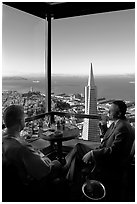 Businessmen with a bottle of Champagne in the Carnelian Room with panoramic view of the City. San Francisco, California, USA (black and white)