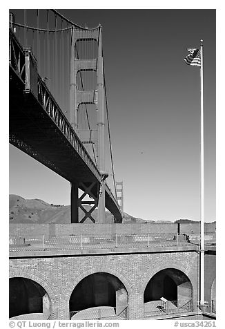 Fort Point courtyard, flag pole, and Golden Gate Bridge. San Francisco, California, USA