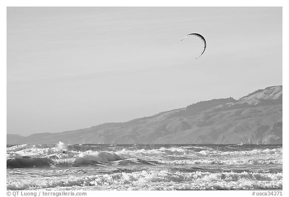 Kite surfer in Pacific Ocean waves, afternoon. San Francisco, California, USA (black and white)