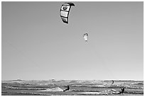 Kite surfers and Pacific Ocean waves, late afternoon. San Francisco, California, USA (black and white)