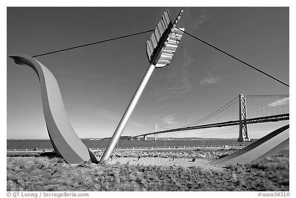 Modern sculputure called Cupid's arrow, framing the Bay Bridge. San Francisco, California, USA (black and white)