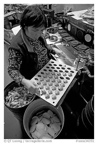 Fortune cookies being folded with great dexterity, Chinatown. San Francisco, California, USA