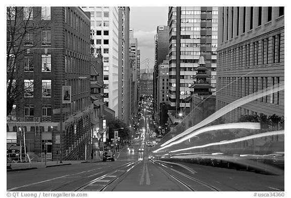 Cable-car rails,  Chinatown, Financial district, and Bay Bridge seen on California street. San Francisco, California, USA