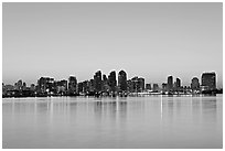 Skyline reflected in the waters of harbor, dawn. San Diego, California, USA (black and white)