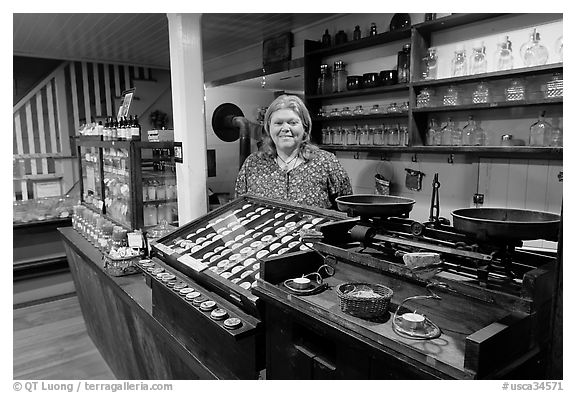 Woman standing behind counter of apothicary store, Old Town. San Diego, California, USA