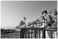 Painter working from an overlook. Laguna Beach, Orange County, California, USA (black and white)