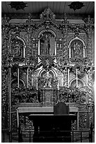 350 year old retablo made of hand-carved wood with a gold leaf overlay. San Juan Capistrano, Orange County, California, USA (black and white)
