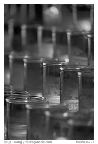 Candles in red glass, background blurred. San Juan Capistrano, Orange County, California, USA (black and white)
