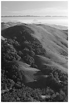 Hills, with coasline and Morro rock in the distance. California, USA (black and white)