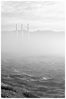 Chimneys of power plant emerging from the fog. Morro Bay, USA ( black and white)