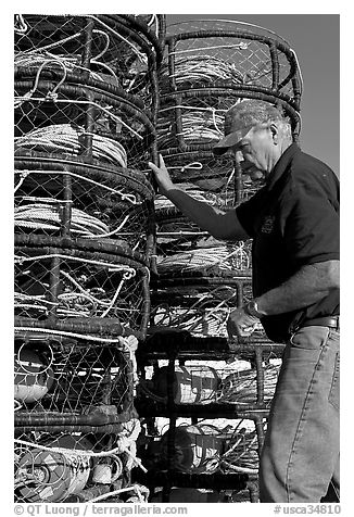 Man loading crab traps. Morro Bay, USA (black and white)