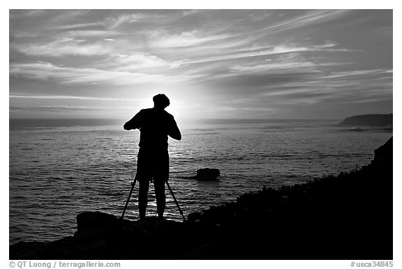Photographer on cliffs at sunset. Santa Cruz, California, USA