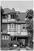 Mansion wing with door opening to a one-story drop. Winchester Mystery House, San Jose, California, USA (black and white)