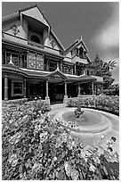 Roses and facade. Winchester Mystery House, San Jose, California, USA (black and white)