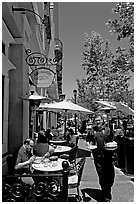 Streetside restaurant terrace and waiter. Santana Row, San Jose, California, USA ( black and white)