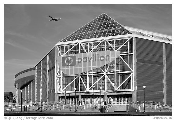 HP Pavilion with person and plane, late afternoon. San Jose, California, USA