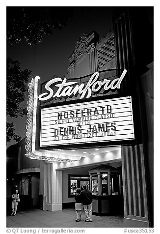 Couple standing in front of Stanford Theatre at night. Palo Alto,  California, USA (black and white)