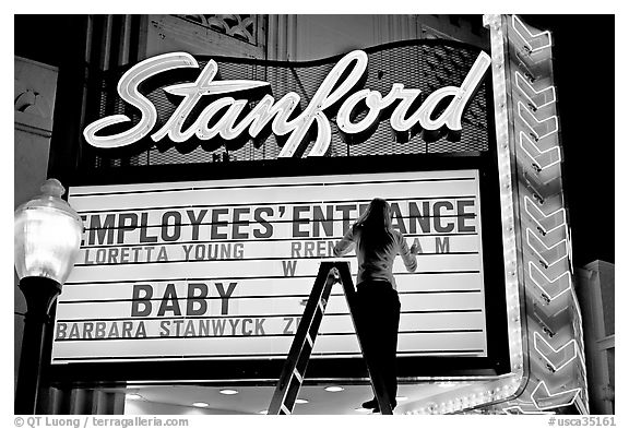 Neon signs and movie title being rearranged, Stanford Theater. Palo Alto,  California, USA (black and white)