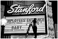 Neon signs and movie title being rearranged, Stanford Theater. Palo Alto,  California, USA (black and white)