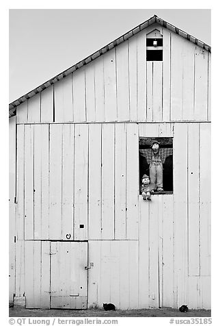 Figures in barn window and cats, Rancho San Antonio Preserve, Los Altos. California, USA (black and white)
