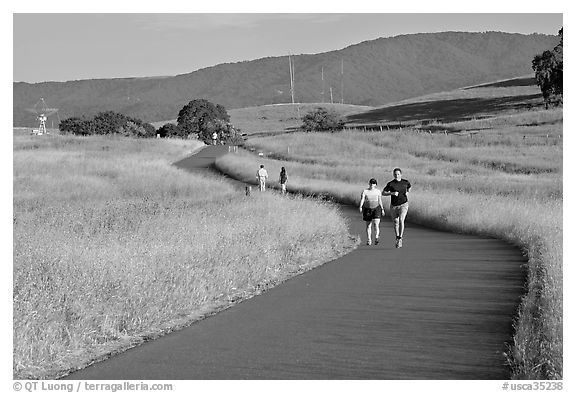 People jogging on trail in the foothills. Stanford University, California, USA