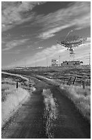 Gravel road leading to parabolic antenna, late afternoon. Stanford University, California, USA (black and white)