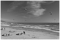 Kitesurfers rolling out sails on on beach, Waddell Creek Beach. California, USA (black and white)